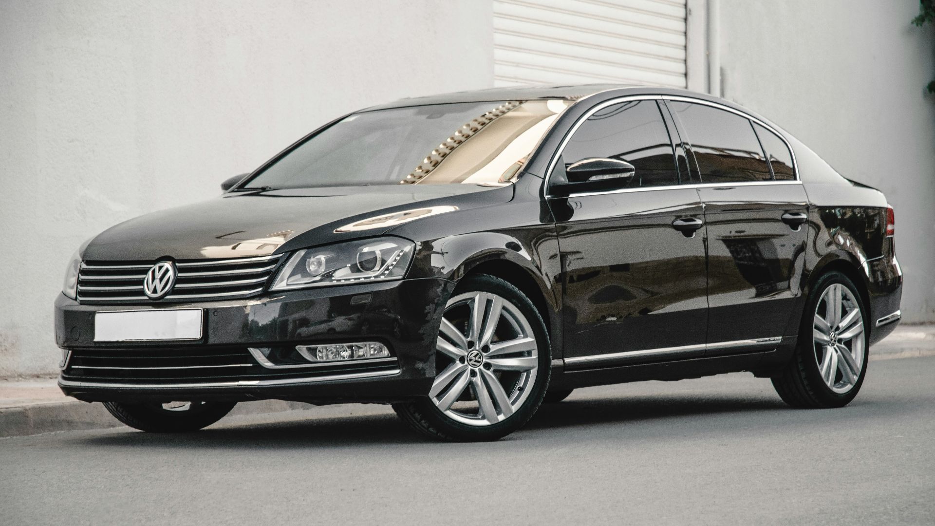 a black car parked in front of a building