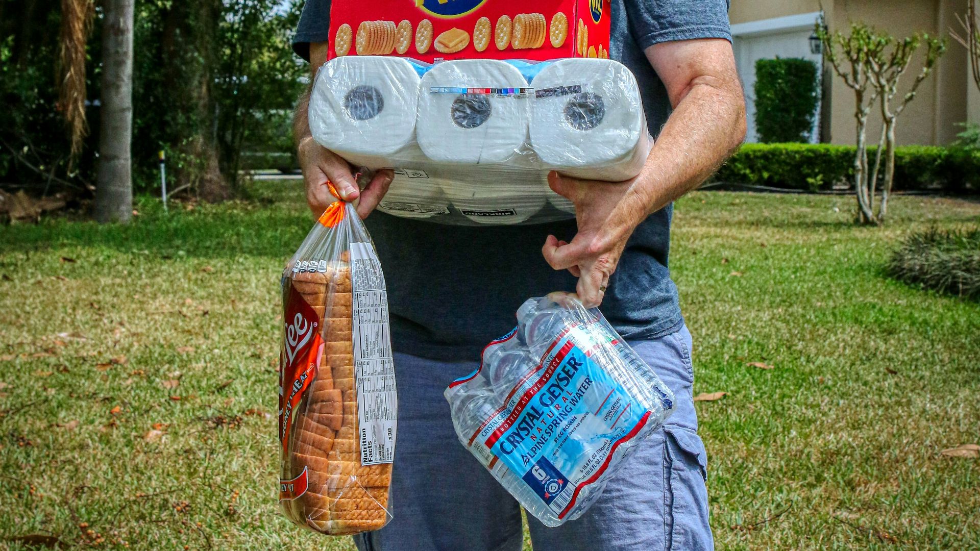 person holding white and red plastic pack