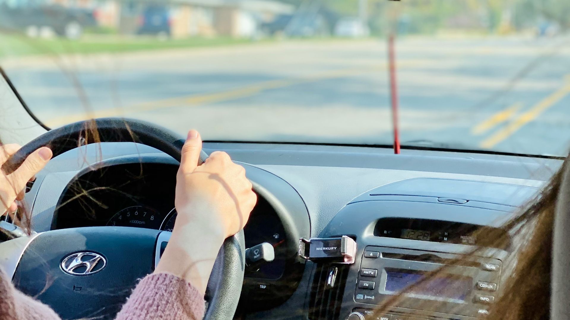 person driving car during daytime