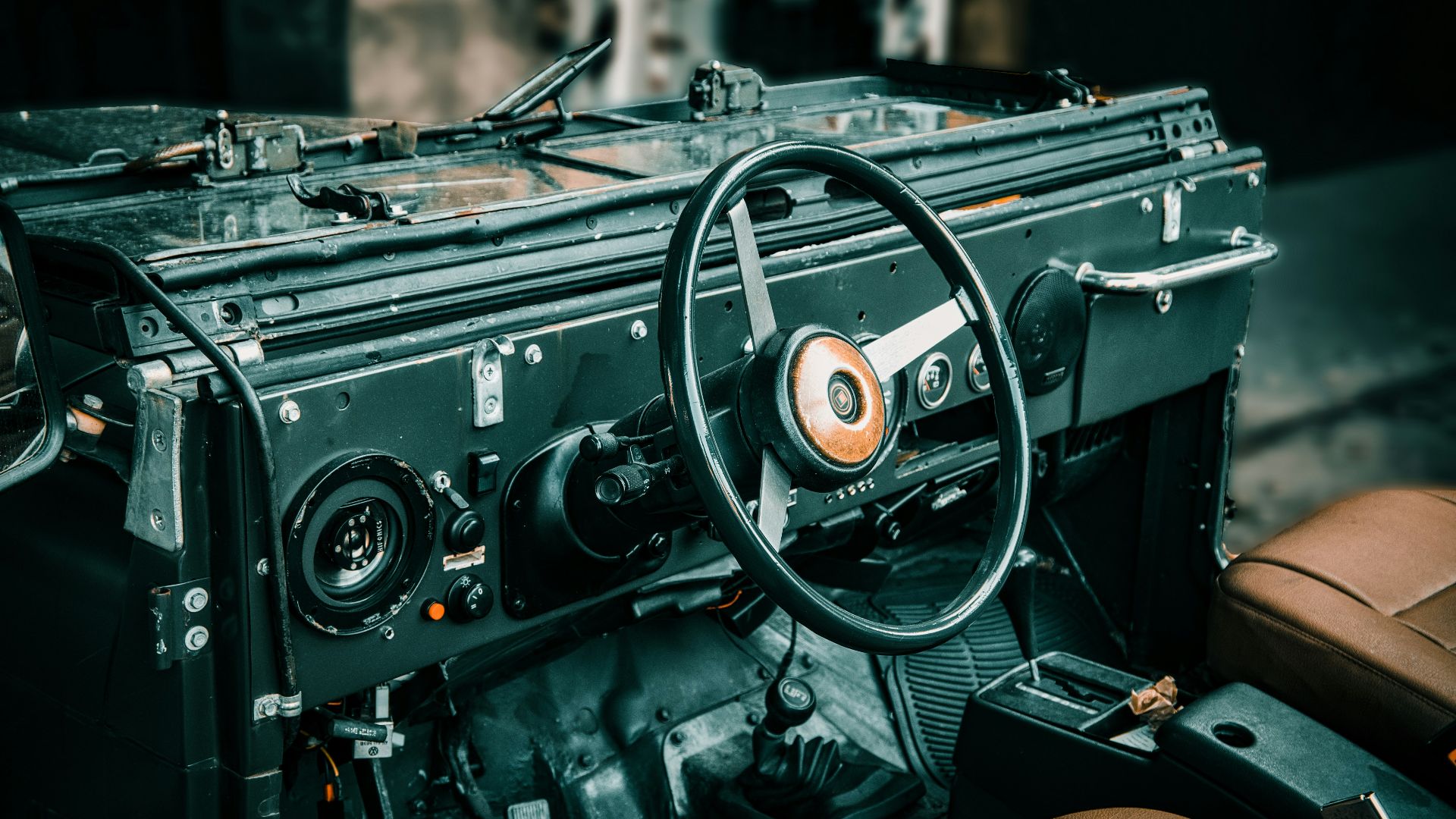 A car dashboard with a brown leather seat