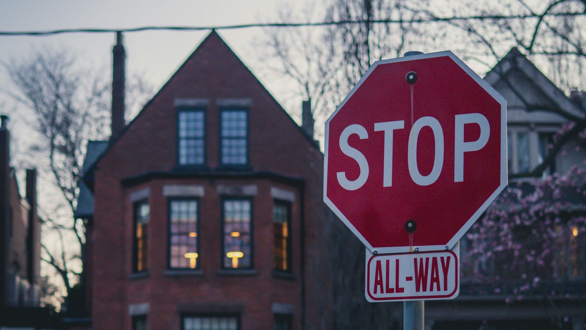 a red stop sign sitting on the side of a road