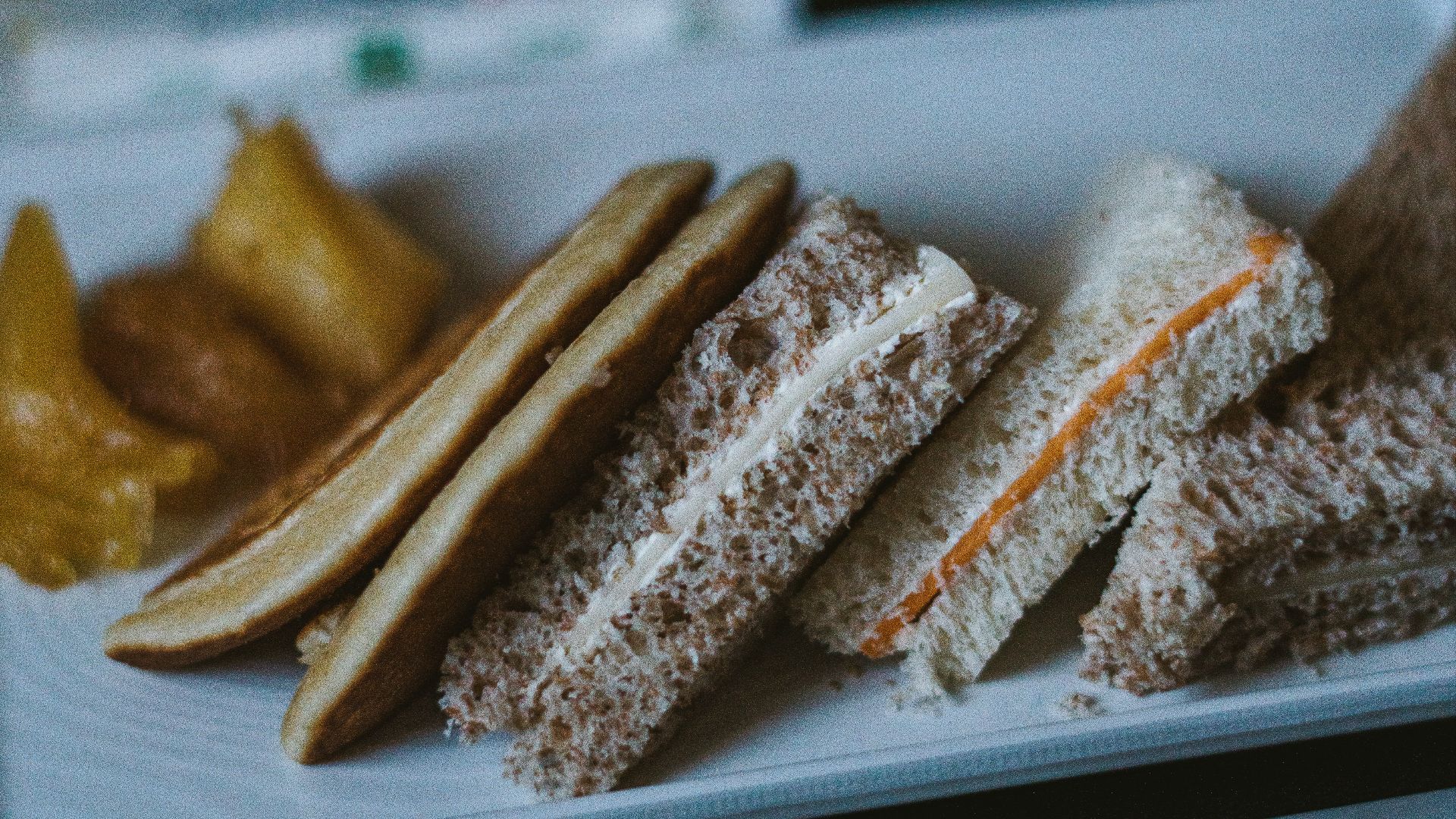 a white plate topped with sandwiches and pickles