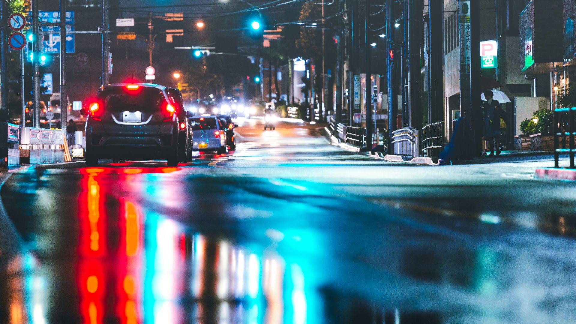 a car driving down a city street at night