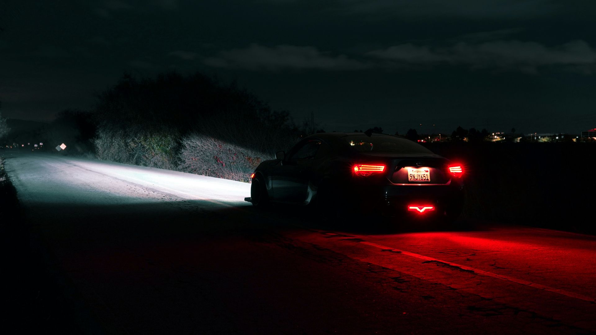 Car driving on a dark road at night