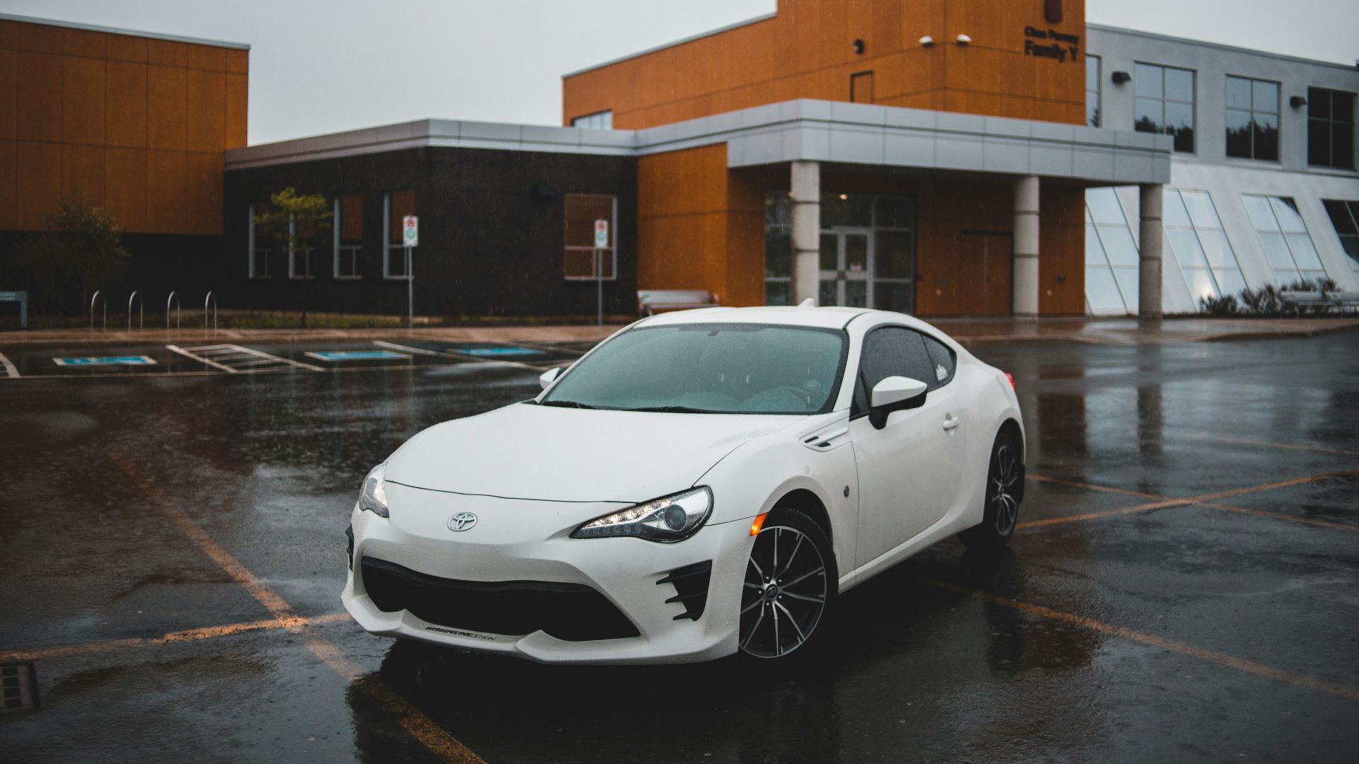 white porsche 911 parked on street during daytime