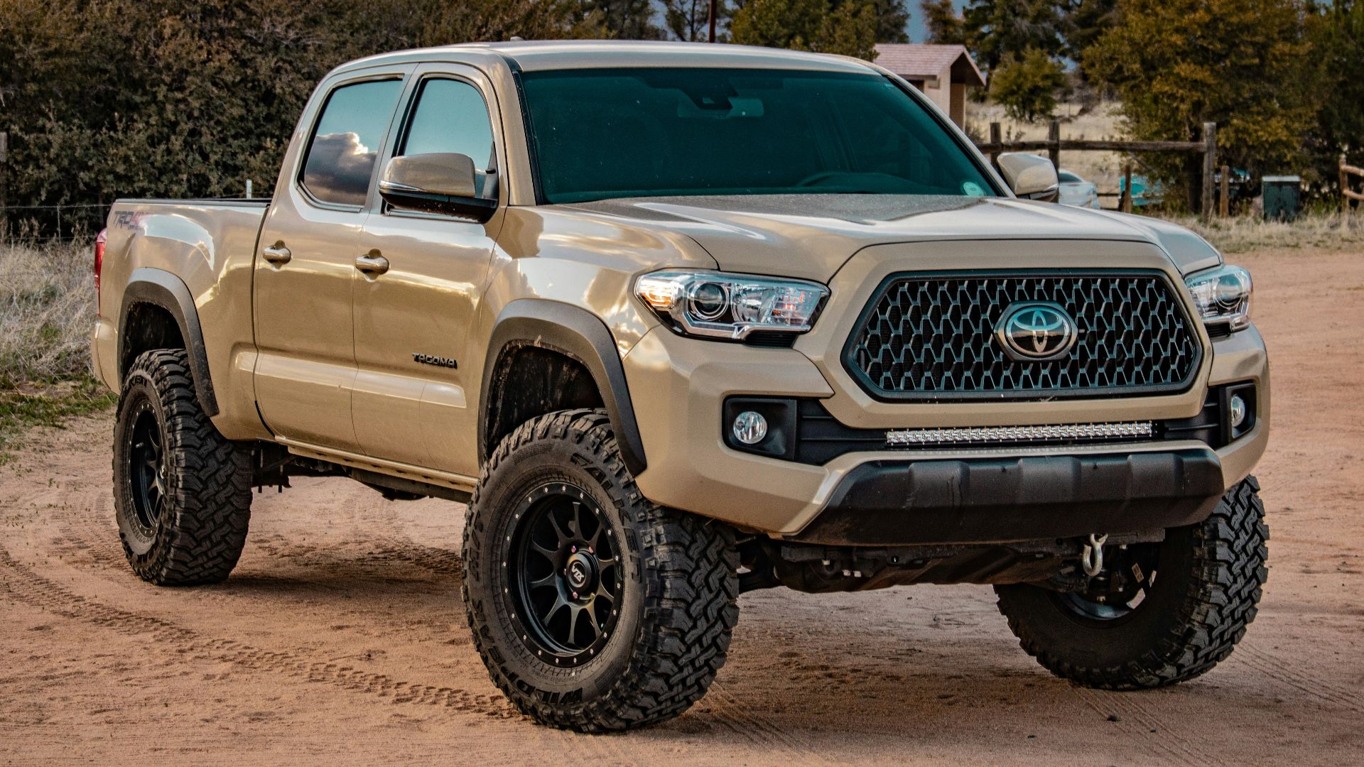 white Toyota crew cab pickup truck on ground