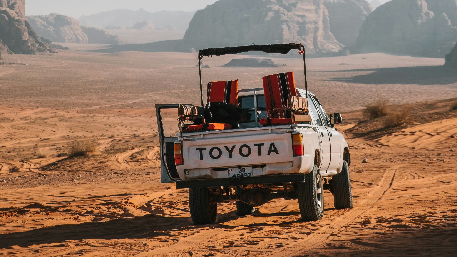 white Toyota crew-cab truck on desert during daytime