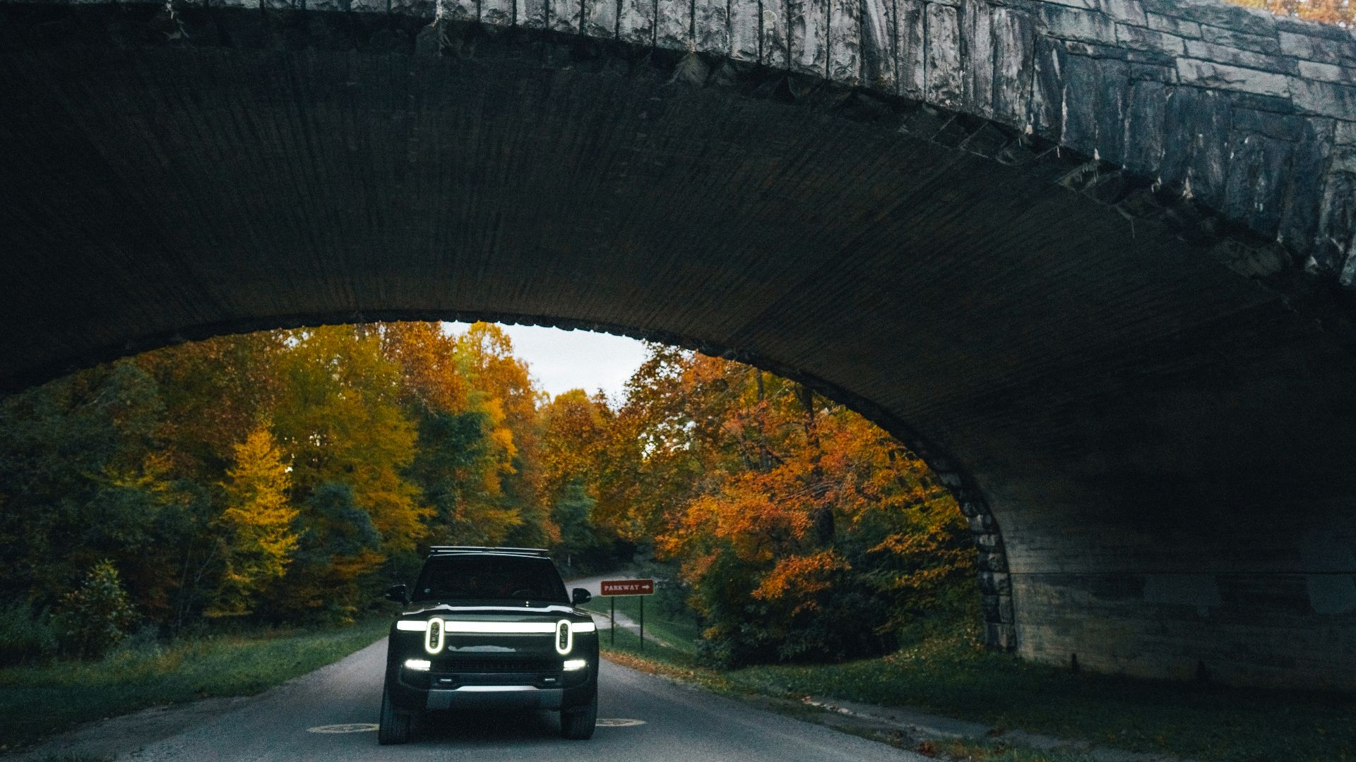 a car driving under a bridge