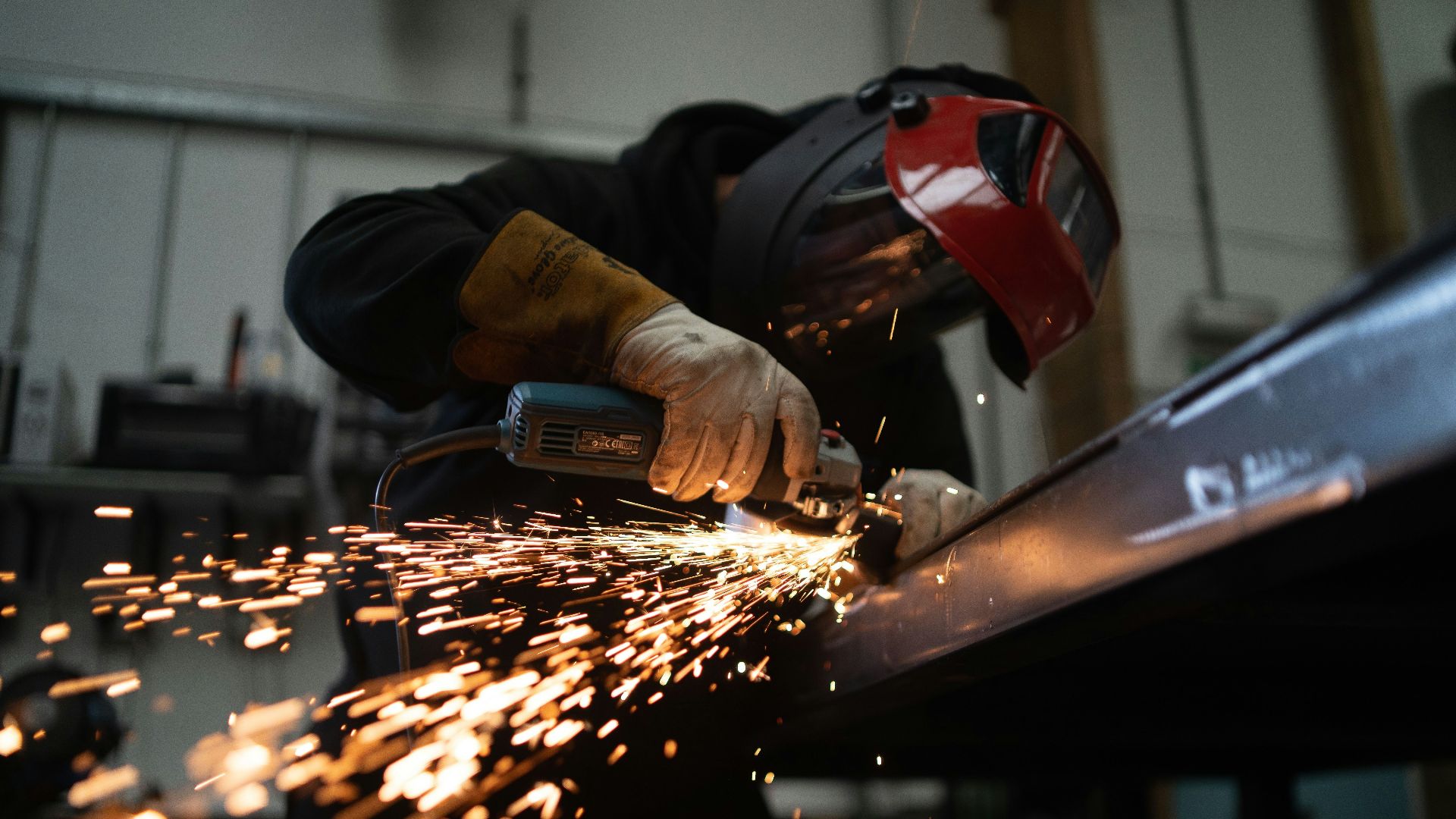 person in black jacket holding brown wooden rolling pin