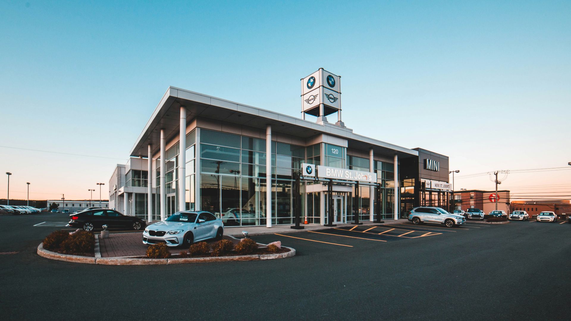 different vehicles near glass walled building