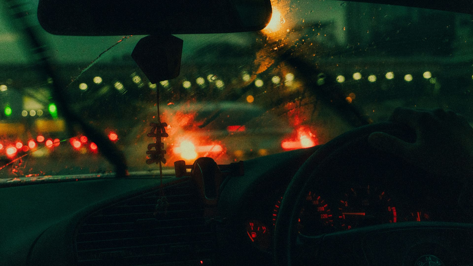Driving through city traffic on a rainy night.