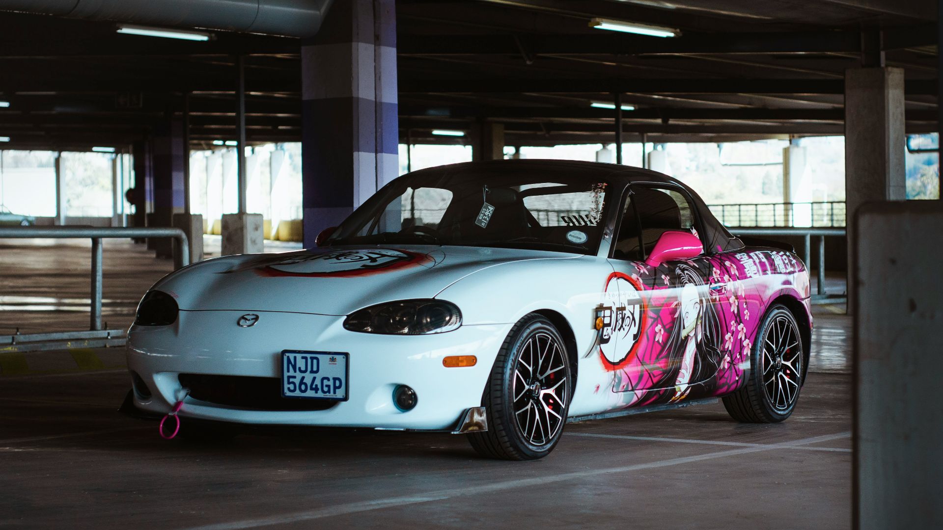 a white car with a pink design on it