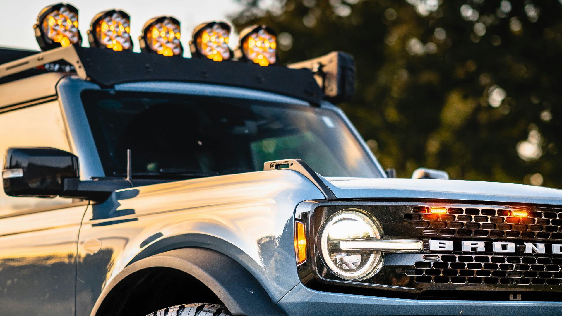 a truck with lights on top of it parked in a parking lot