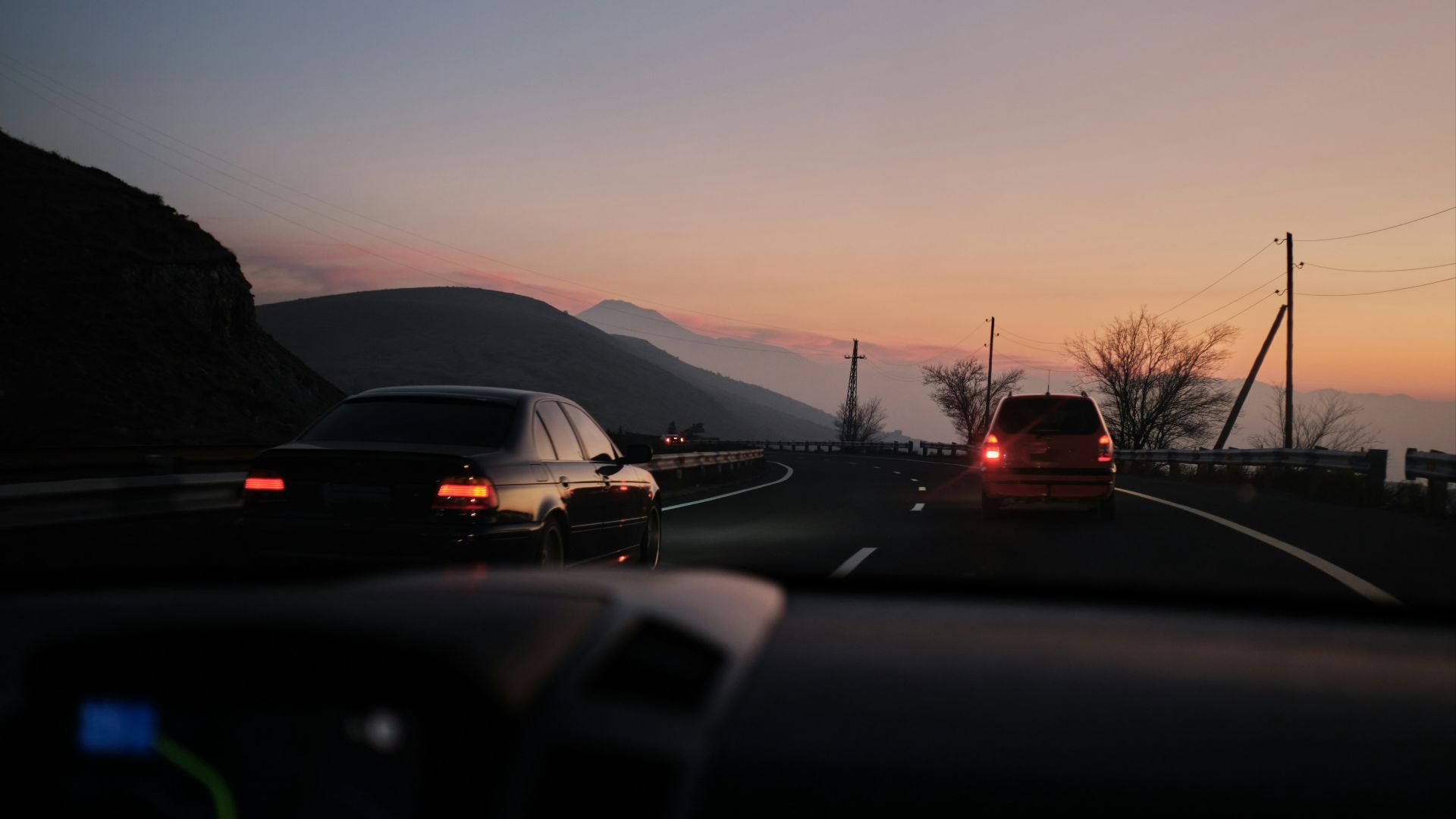 a couple of cars that are sitting in the street