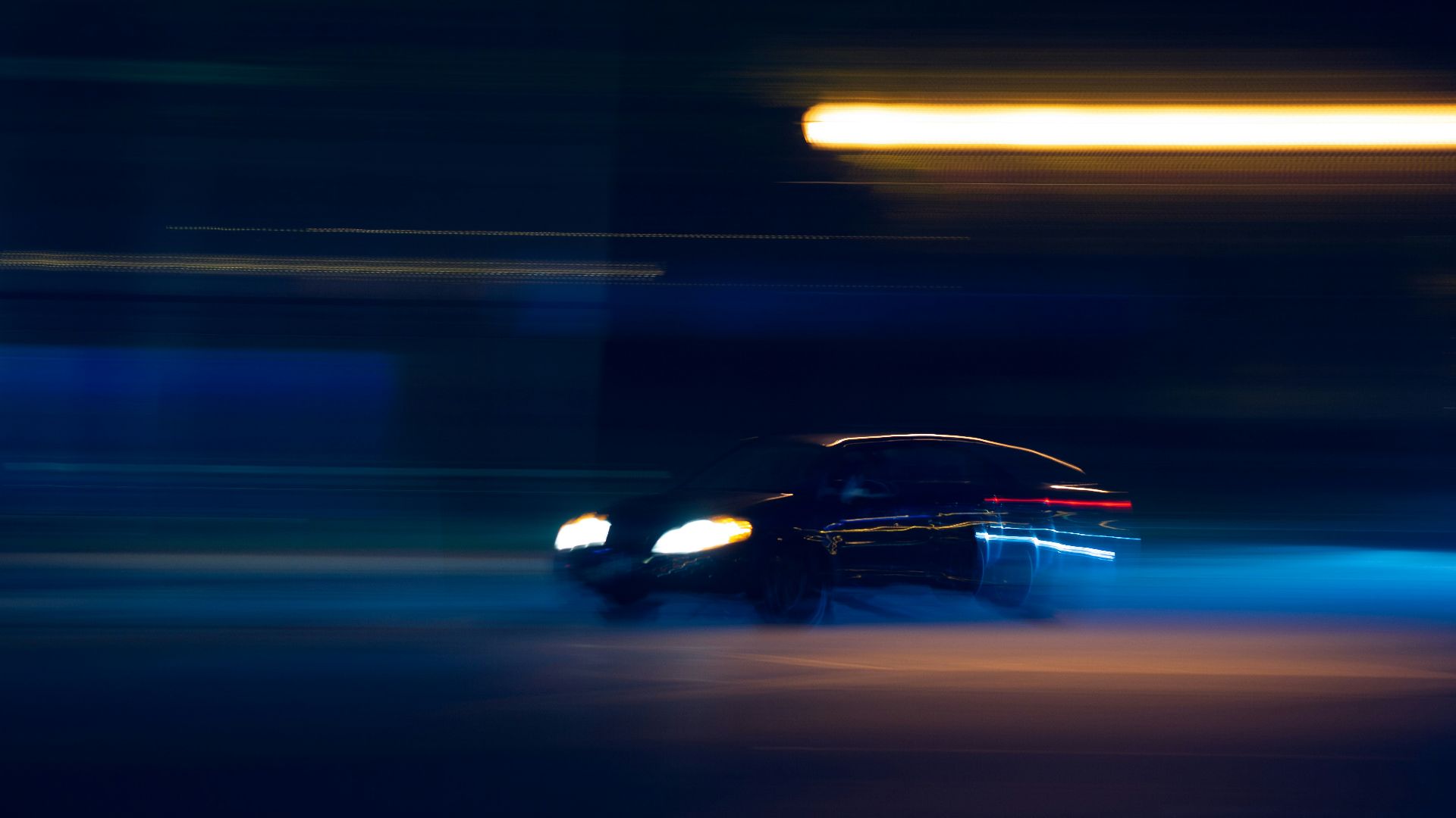 black car on road during night time