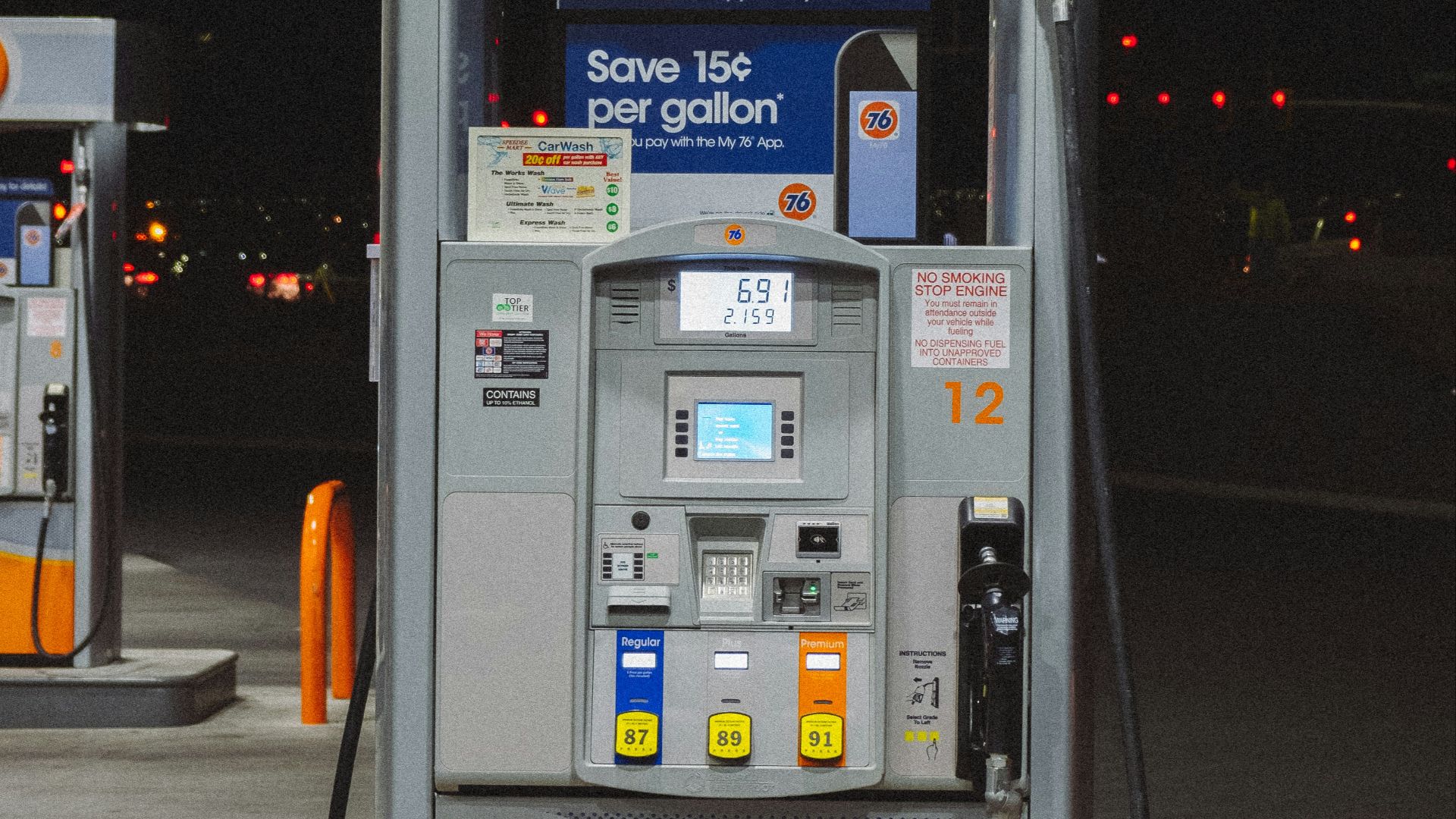 gray and orange gasoline pump