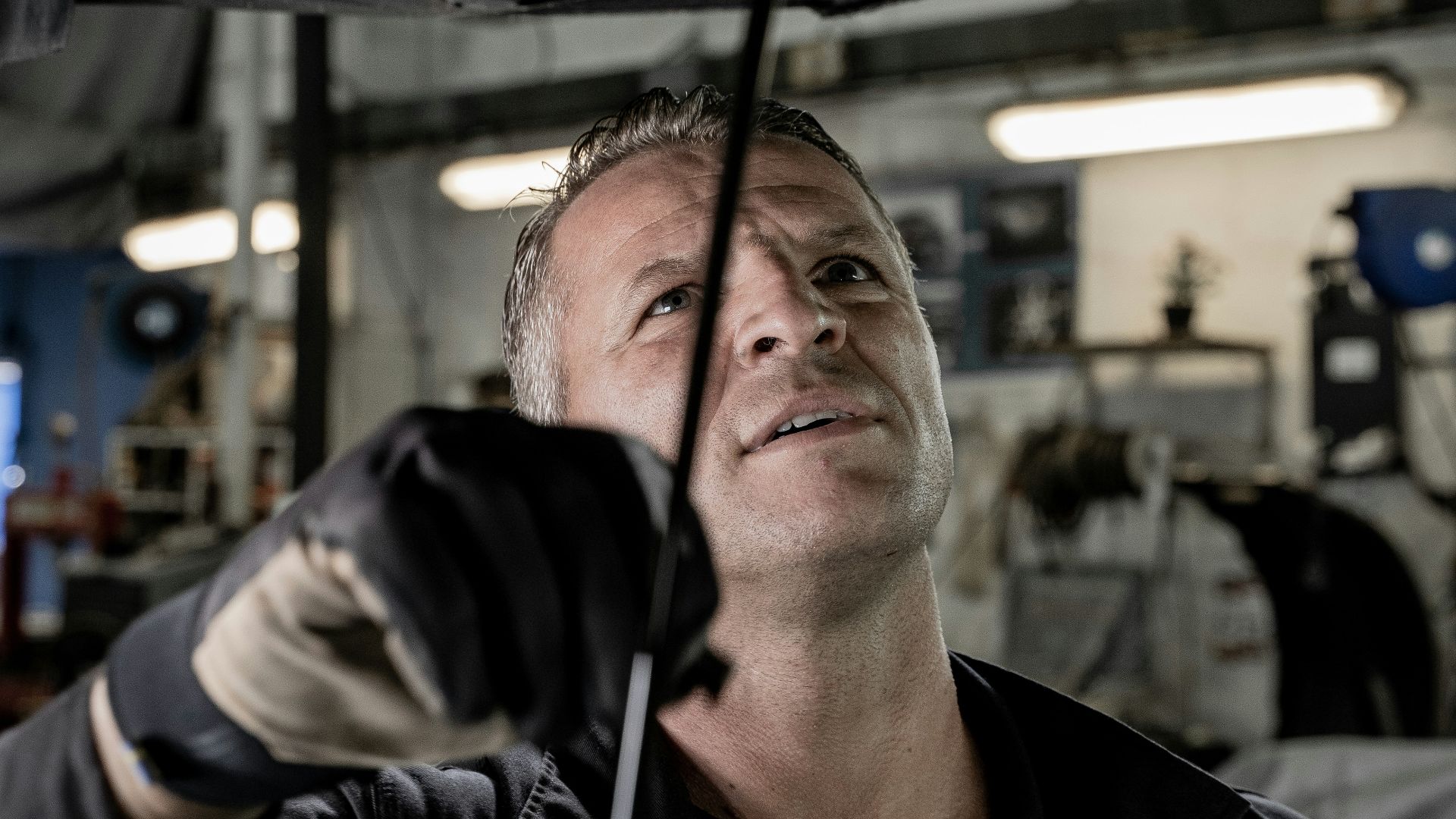 a man working on a car in a garage