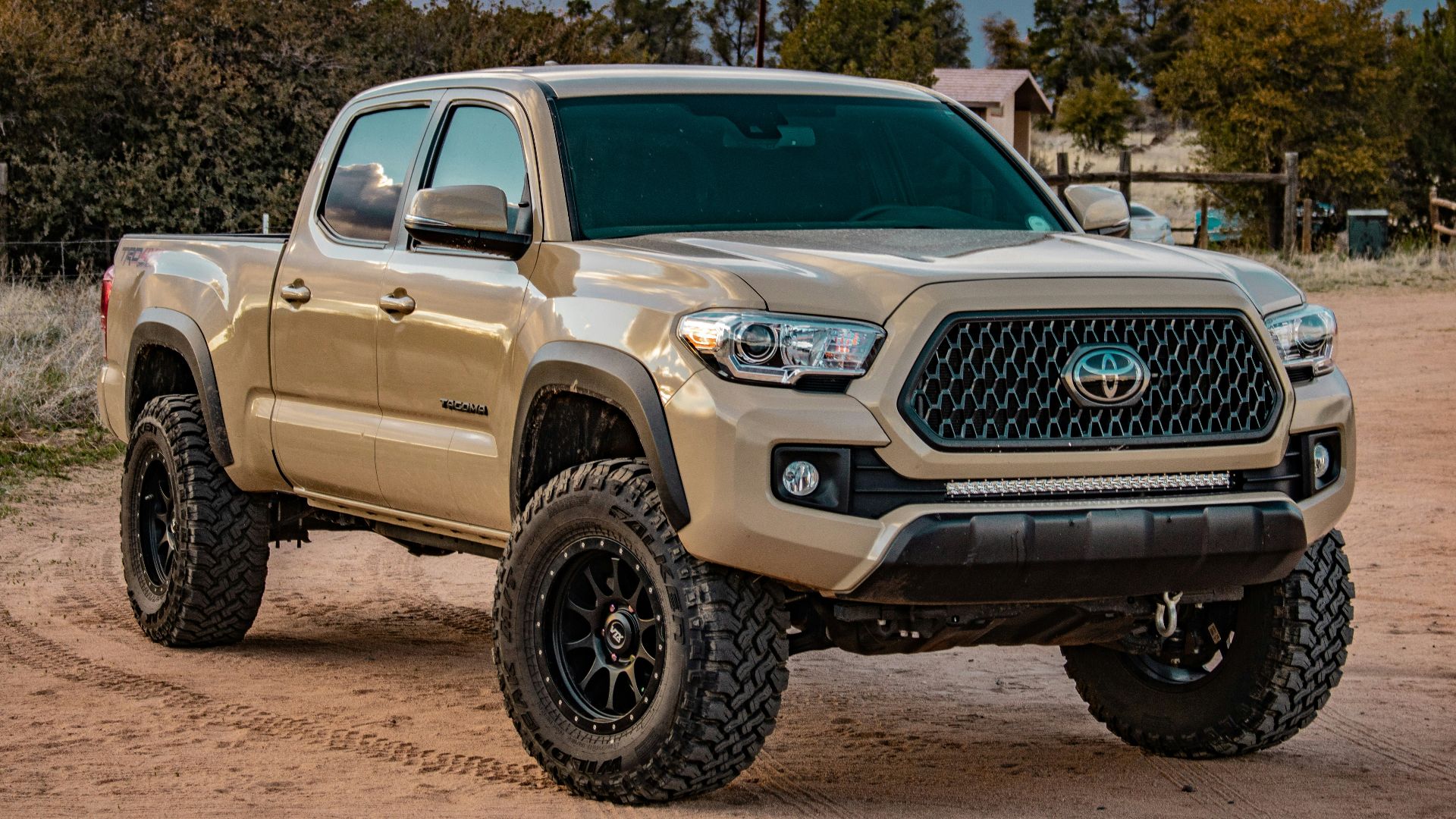 white Toyota crew cab pickup truck on ground