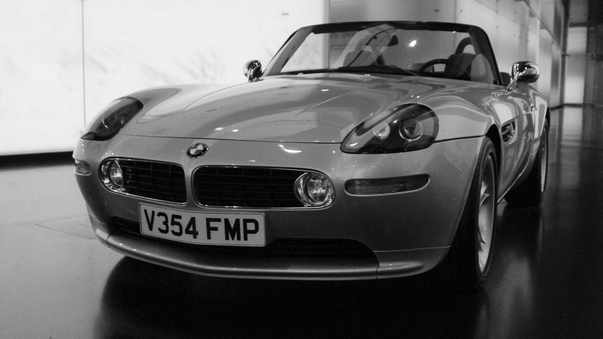 A BMW z8 roadster is showcased indoors.
