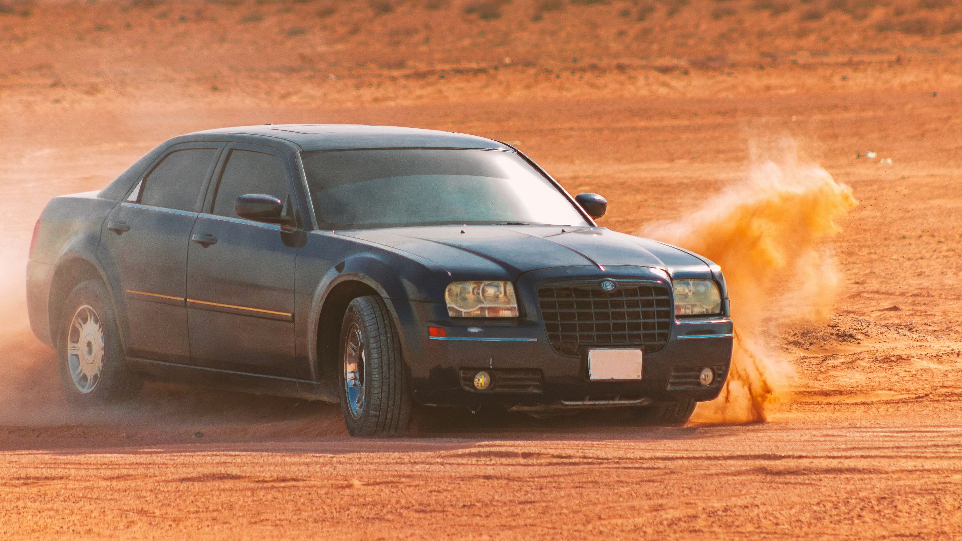 black sedan on brown field during daytime