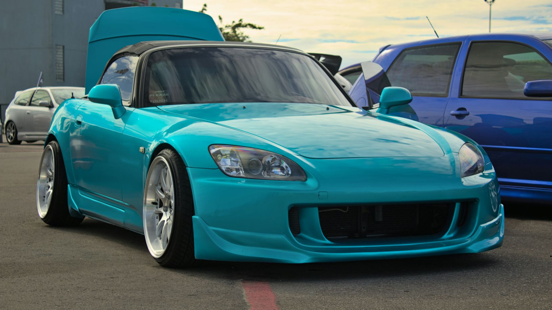 a blue sports car parked in a parking lot