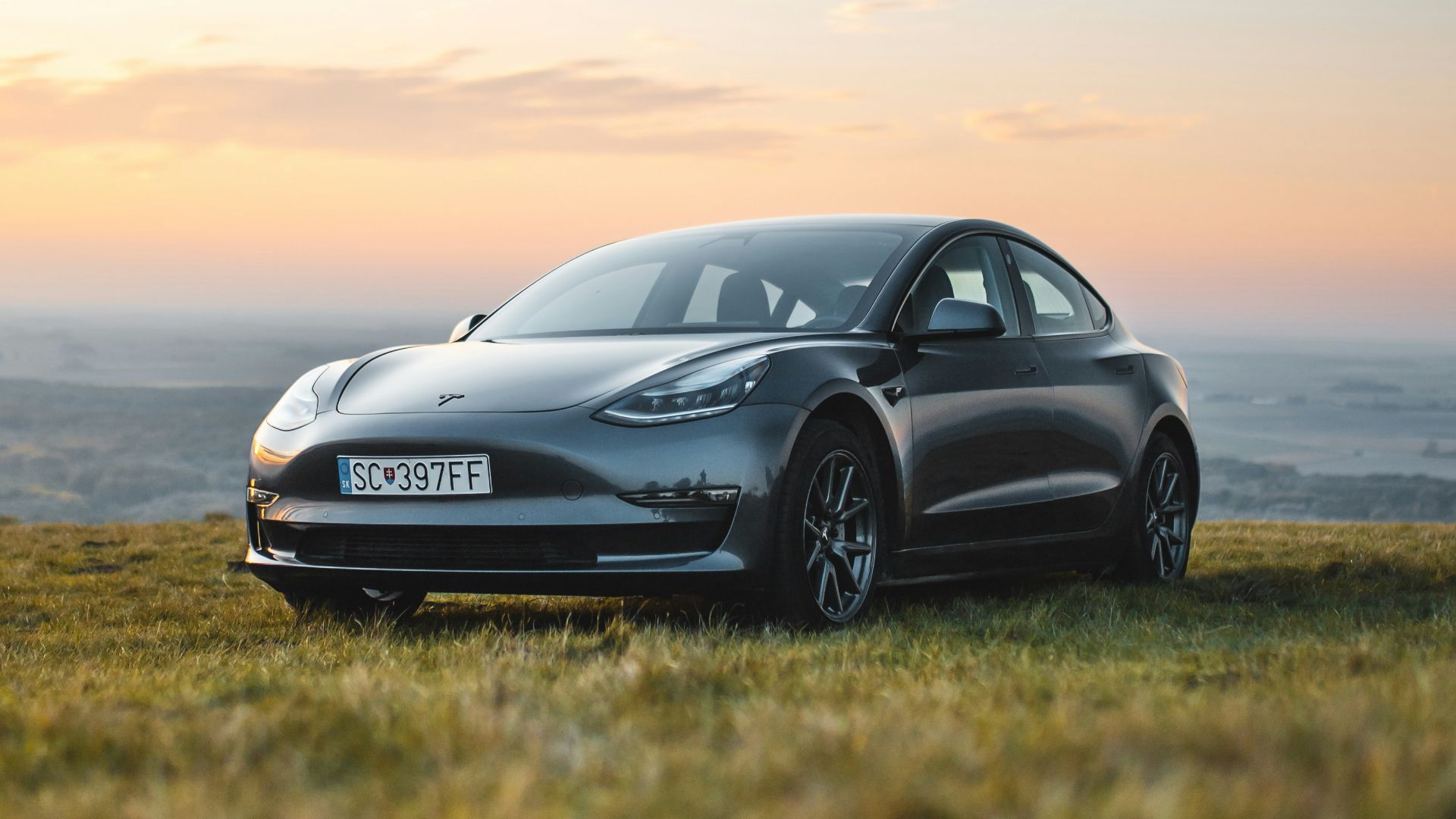 gray vehicle park on grass