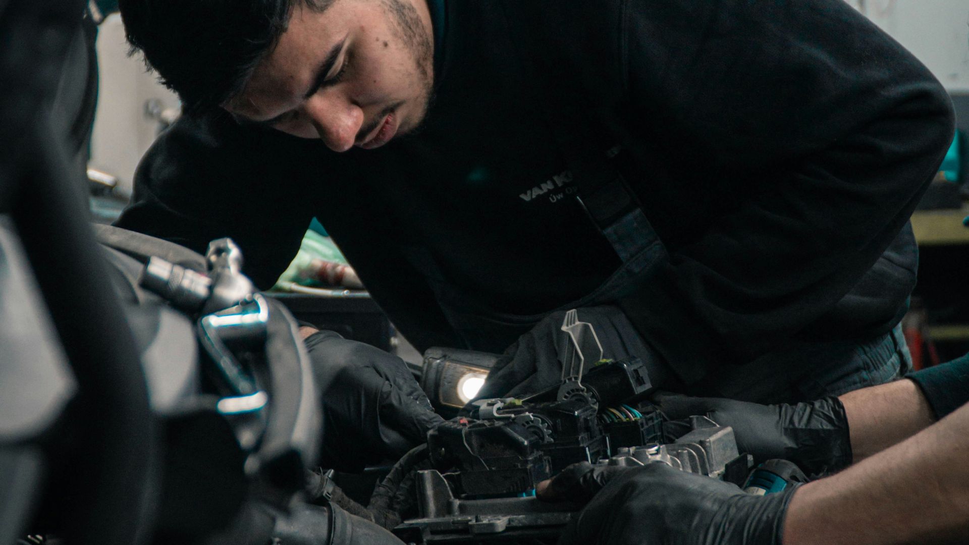 man in black jacket and blue denim jeans riding motorcycle