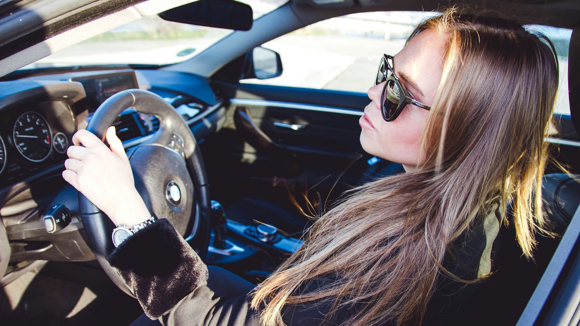 woman in black jacket driving car