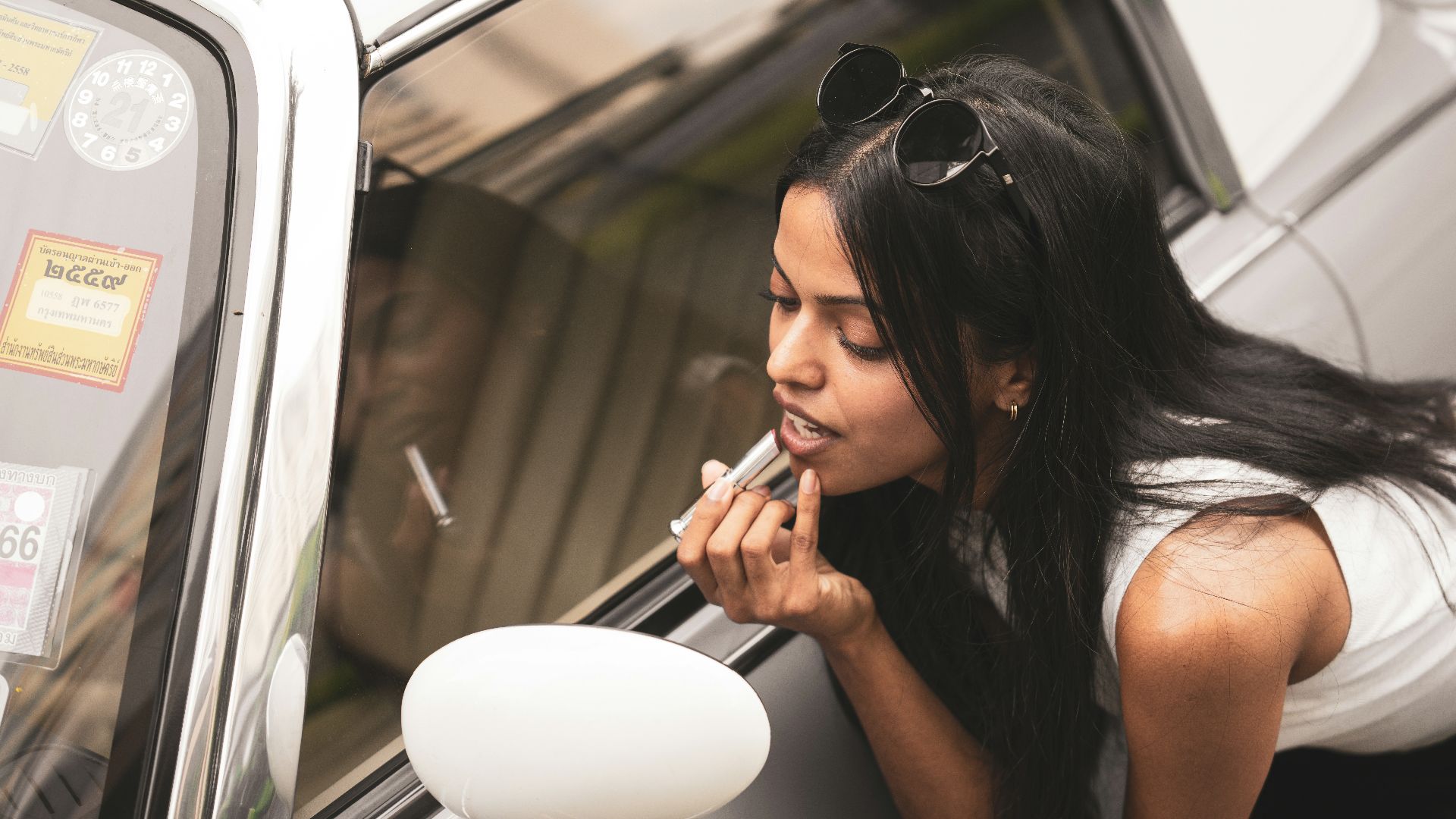 a woman leaning out the window of a car