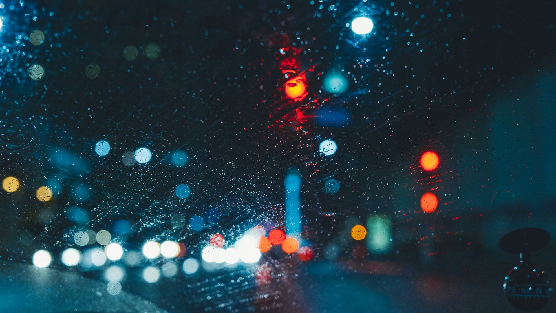 Rainy night scene with city lights blurred.
