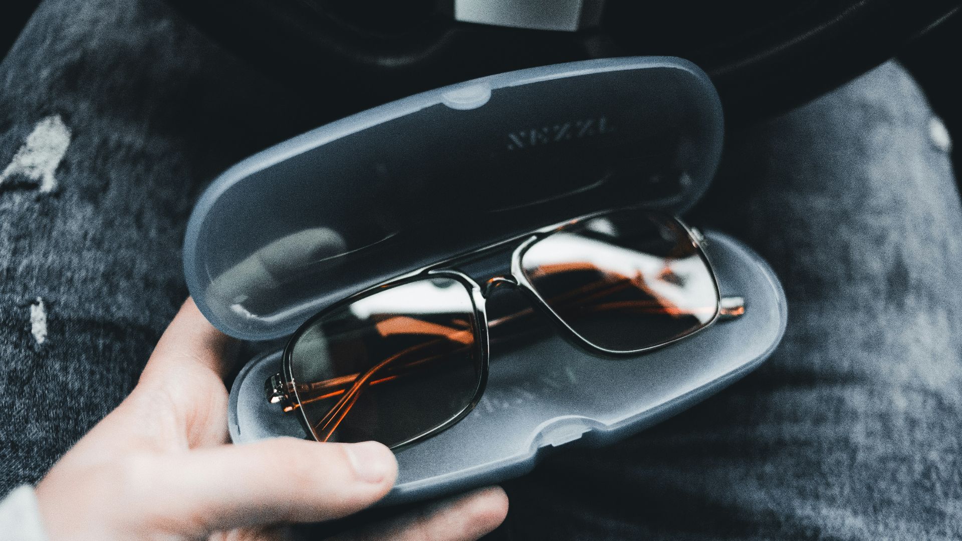 black framed eyeglasses on black case