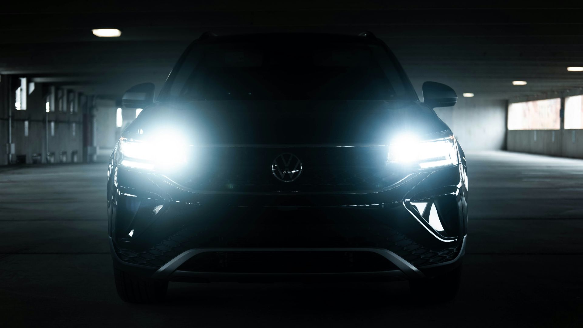 the front of a black car in a parking garage