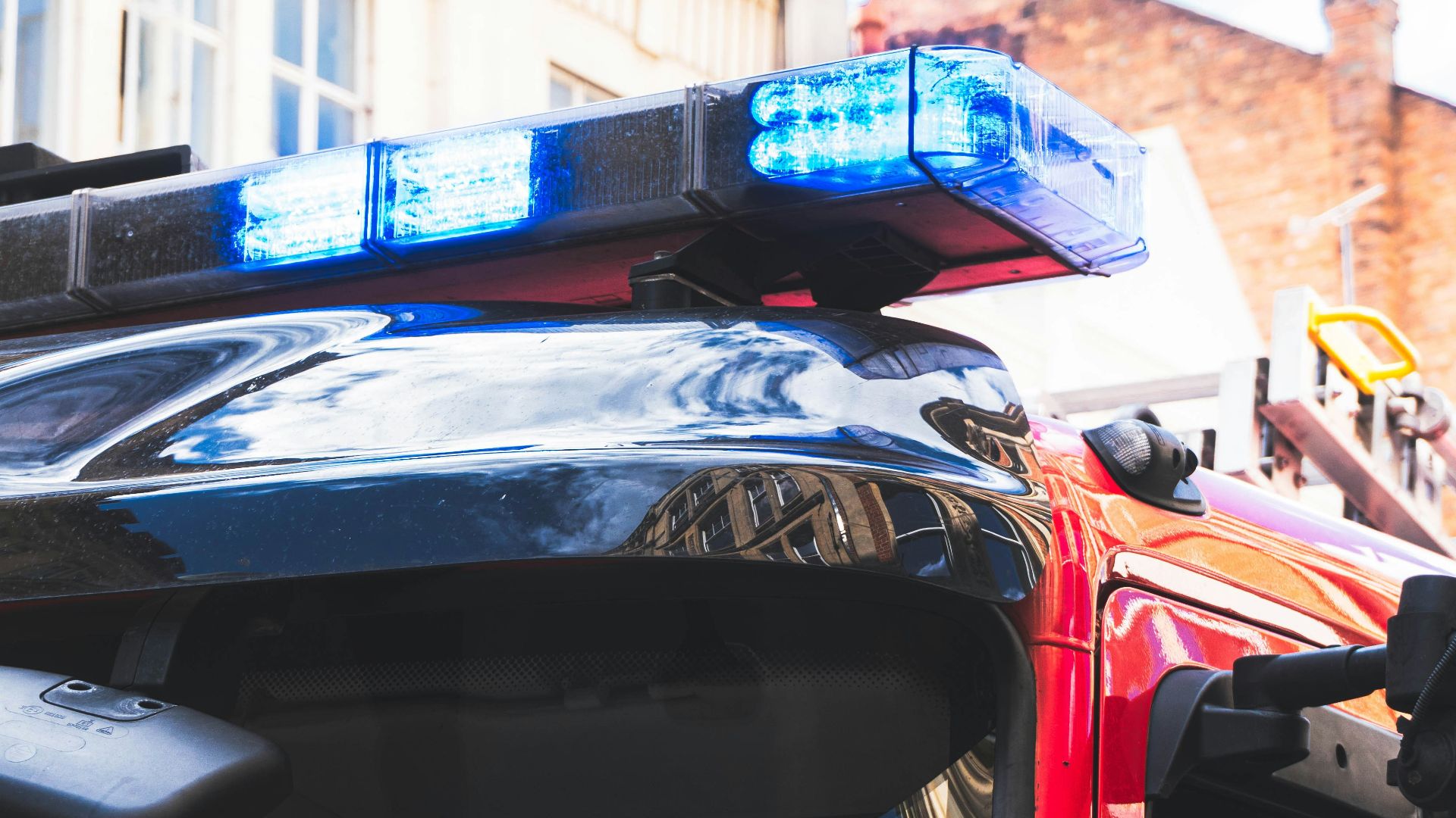black and blue car in front of red car