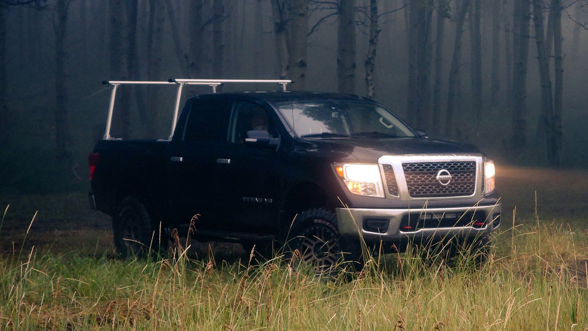 A truck parked in the middle of a forest