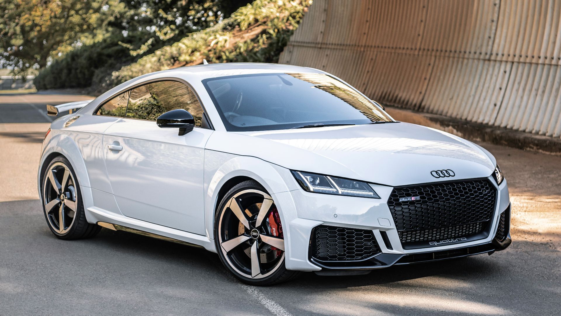white audi r 8 parked near brown wall