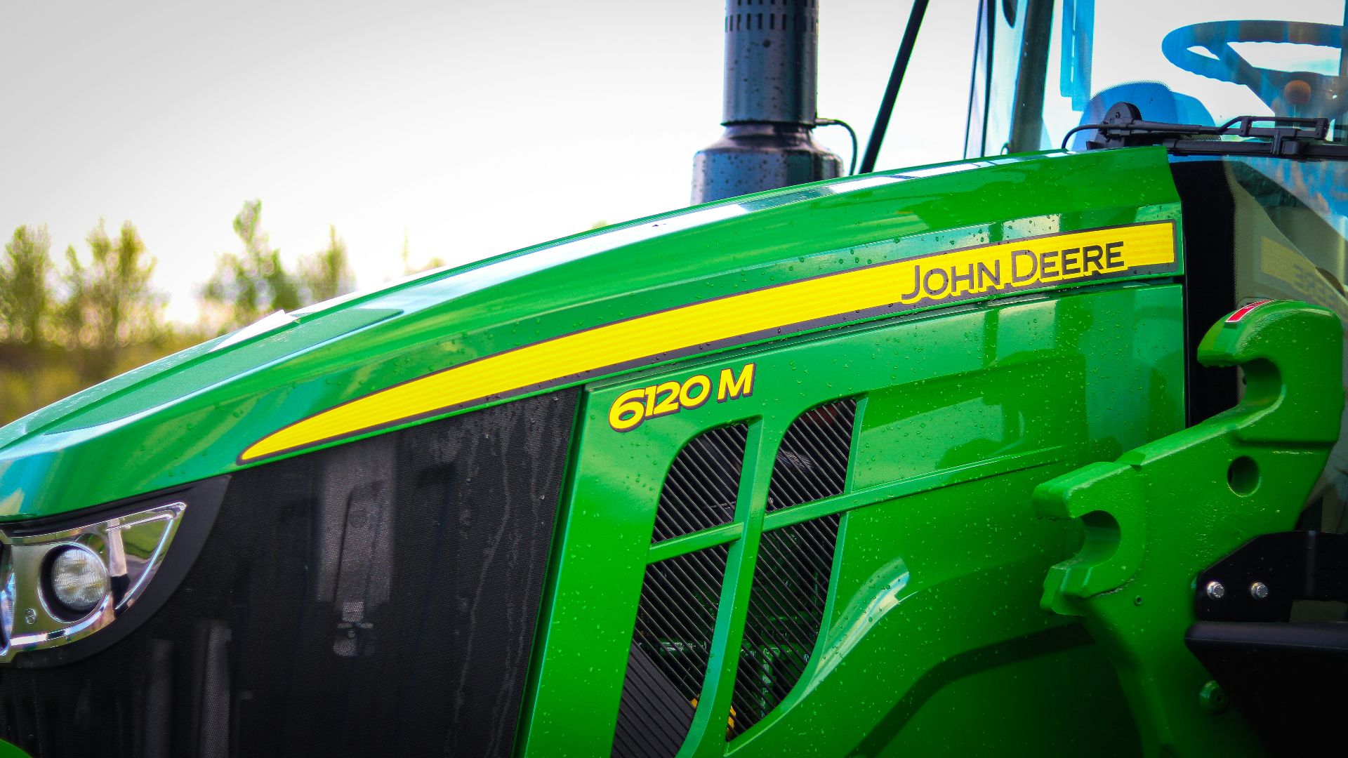 A close up of the front of a green tractor