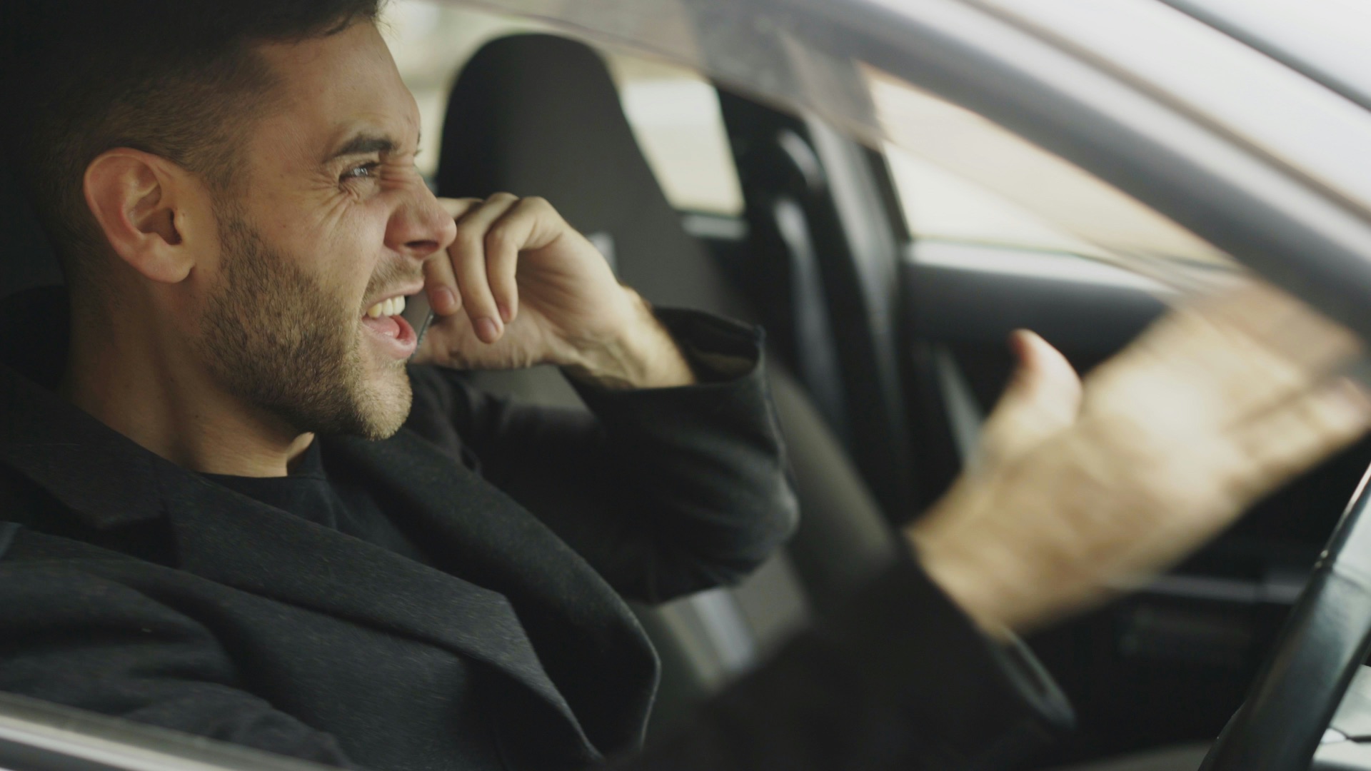 Man talking on phone while driving a car