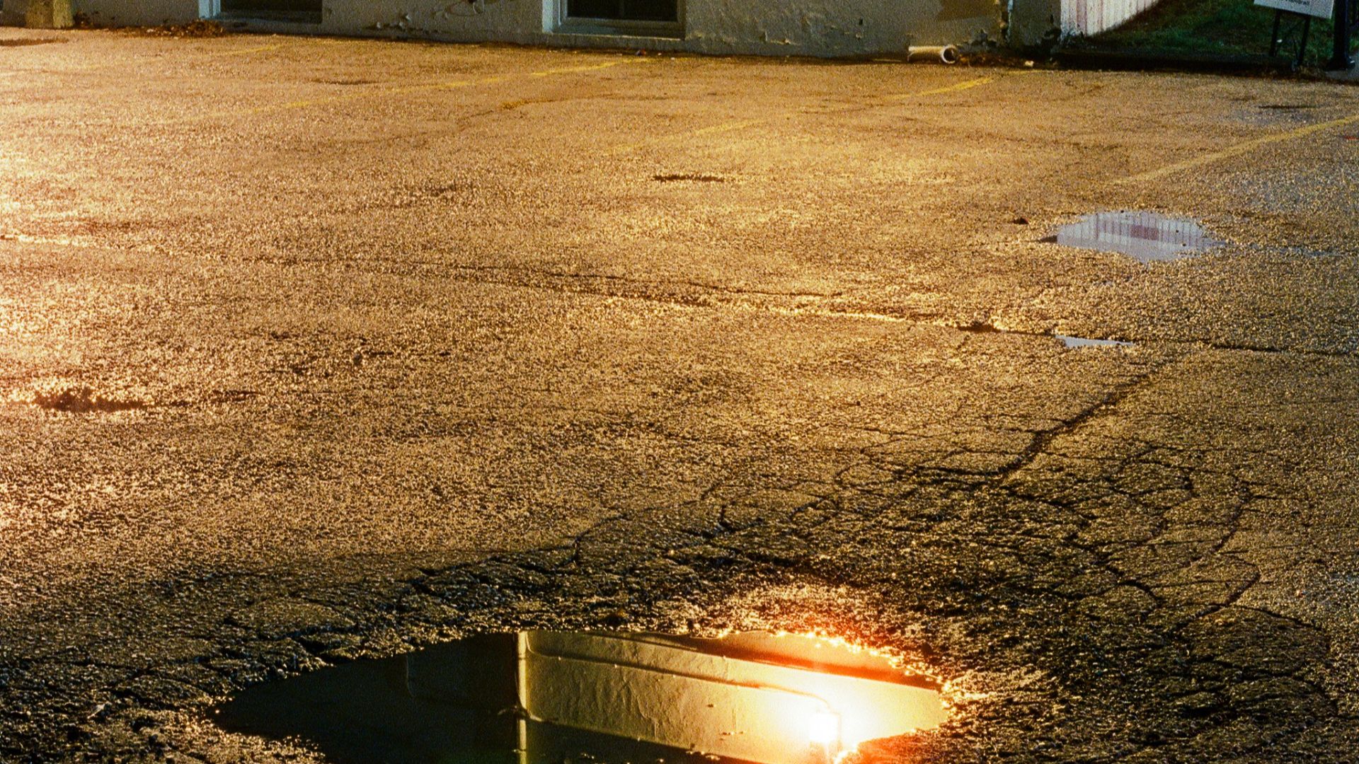 A fire hydrant sitting in the middle of a parking lot