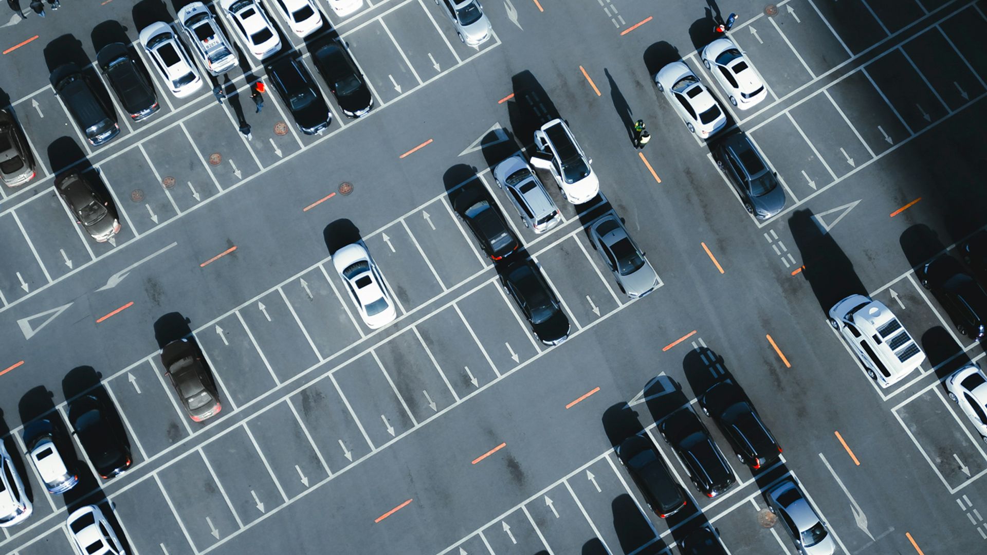 a parking lot filled with lots of parked cars
