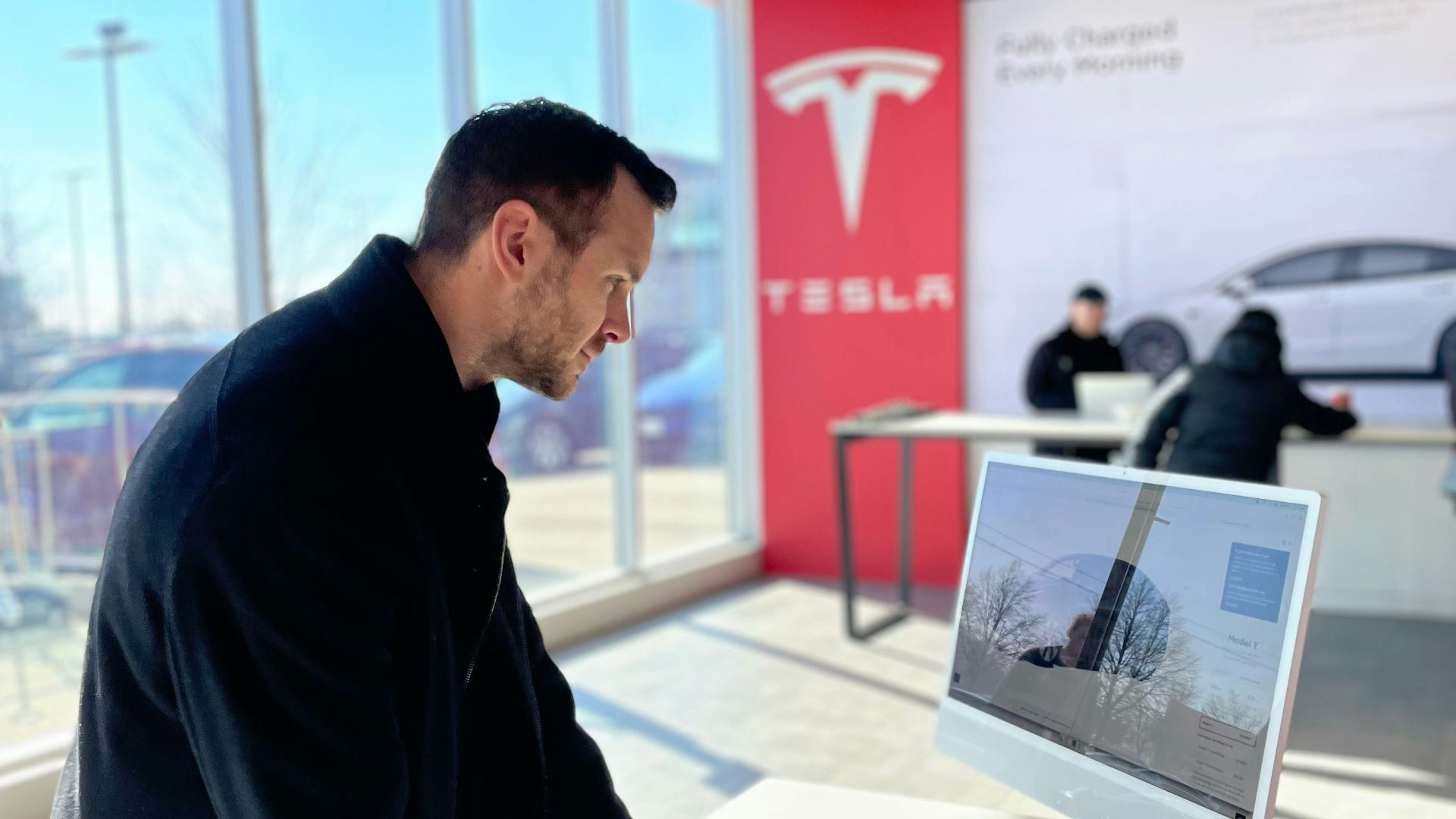 a man sitting at a desk in front of a computer