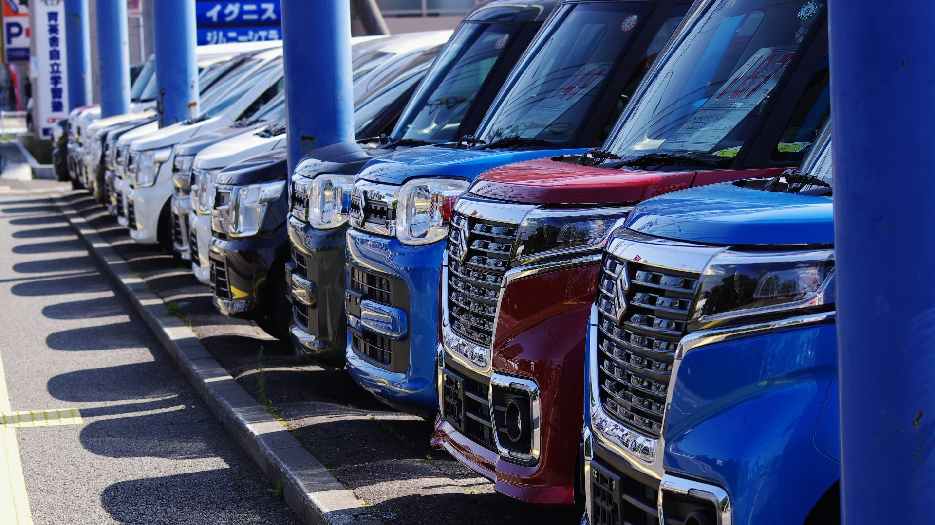 blue and silver cars on parking lot during daytime