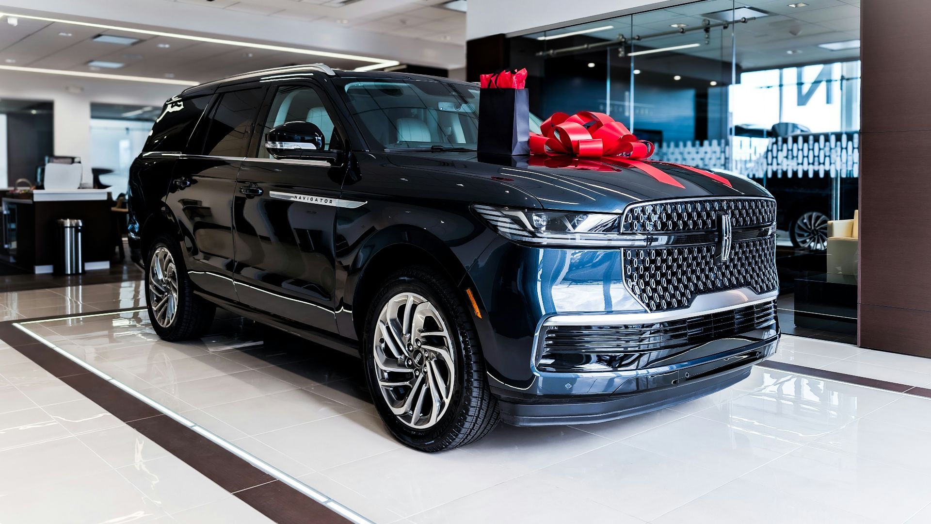 Dark blue luxury suv with red bow on hood
