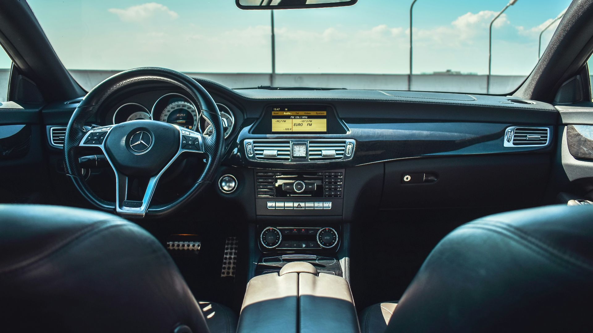 black Mercedes-Benz vehicle steering wheel