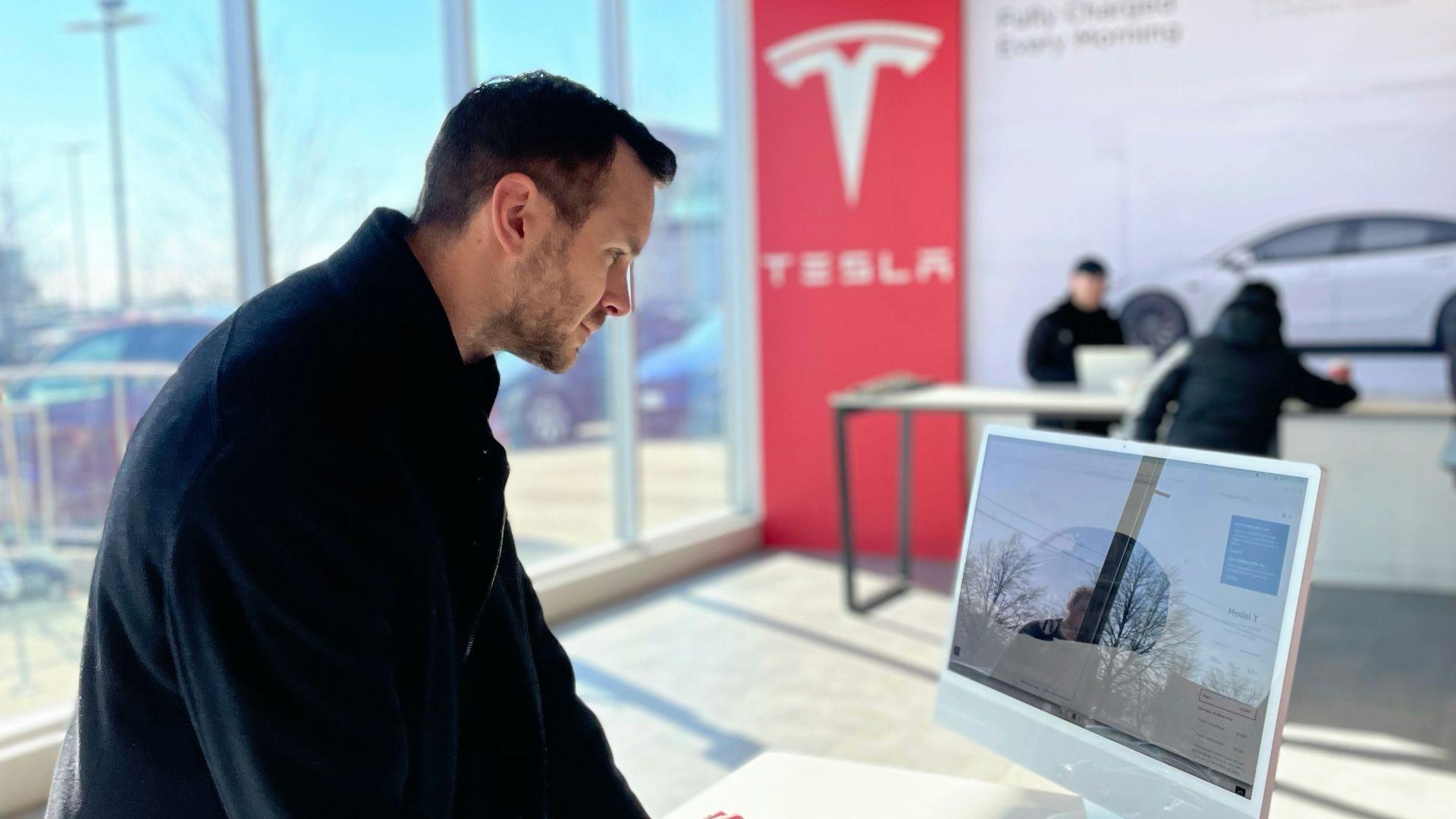 a man sitting at a desk in front of a computer