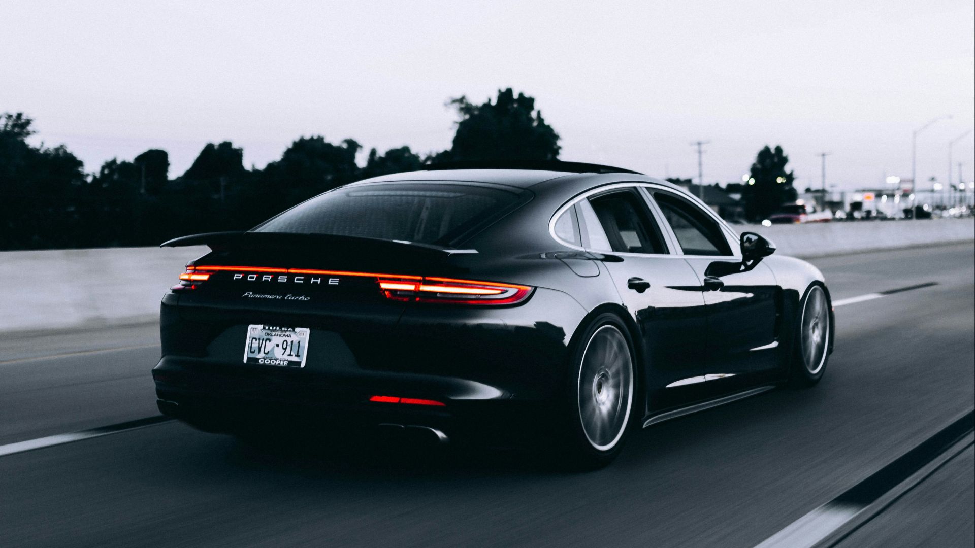 running black Porsche sedan