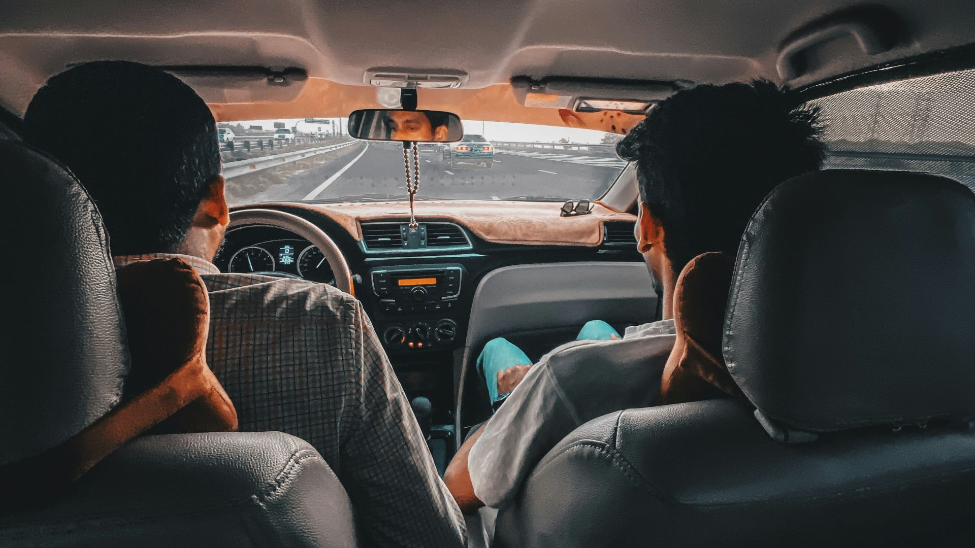 man in black shirt driving car