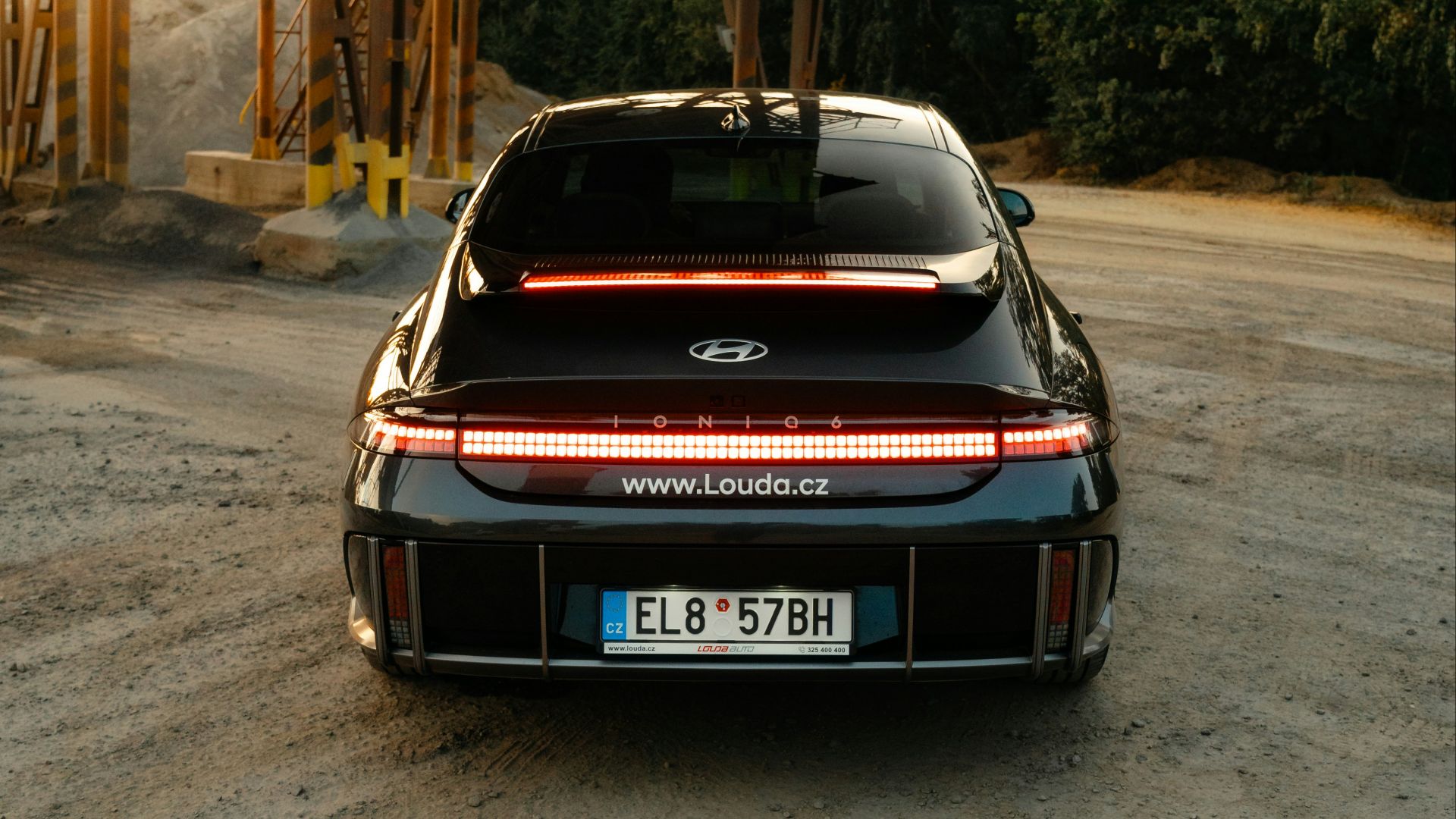 a car parked in front of a wooden structure