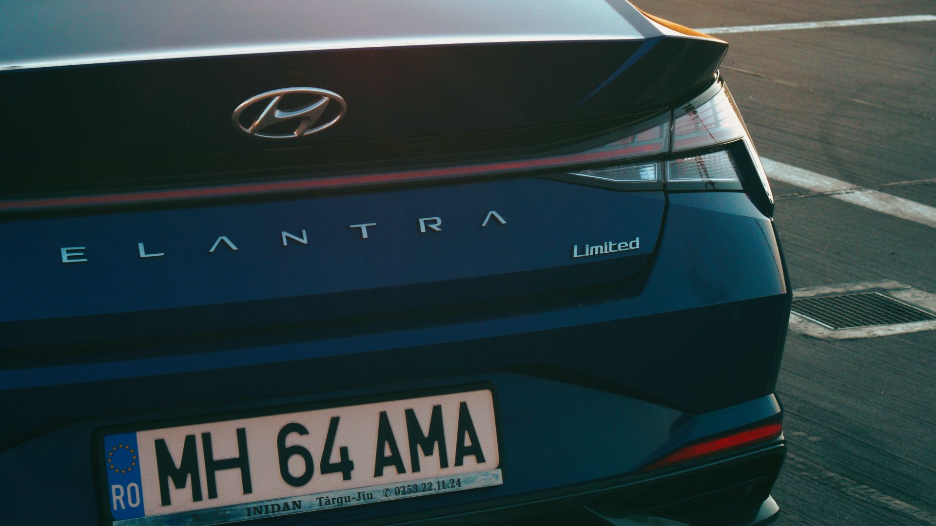 a blue car parked in a parking lot