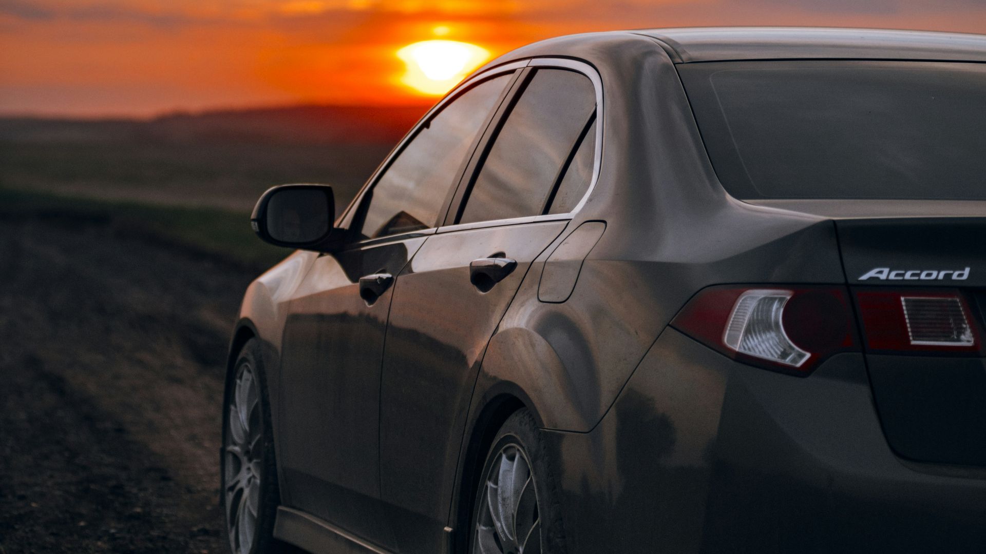 a car parked on the side of a dirt road
