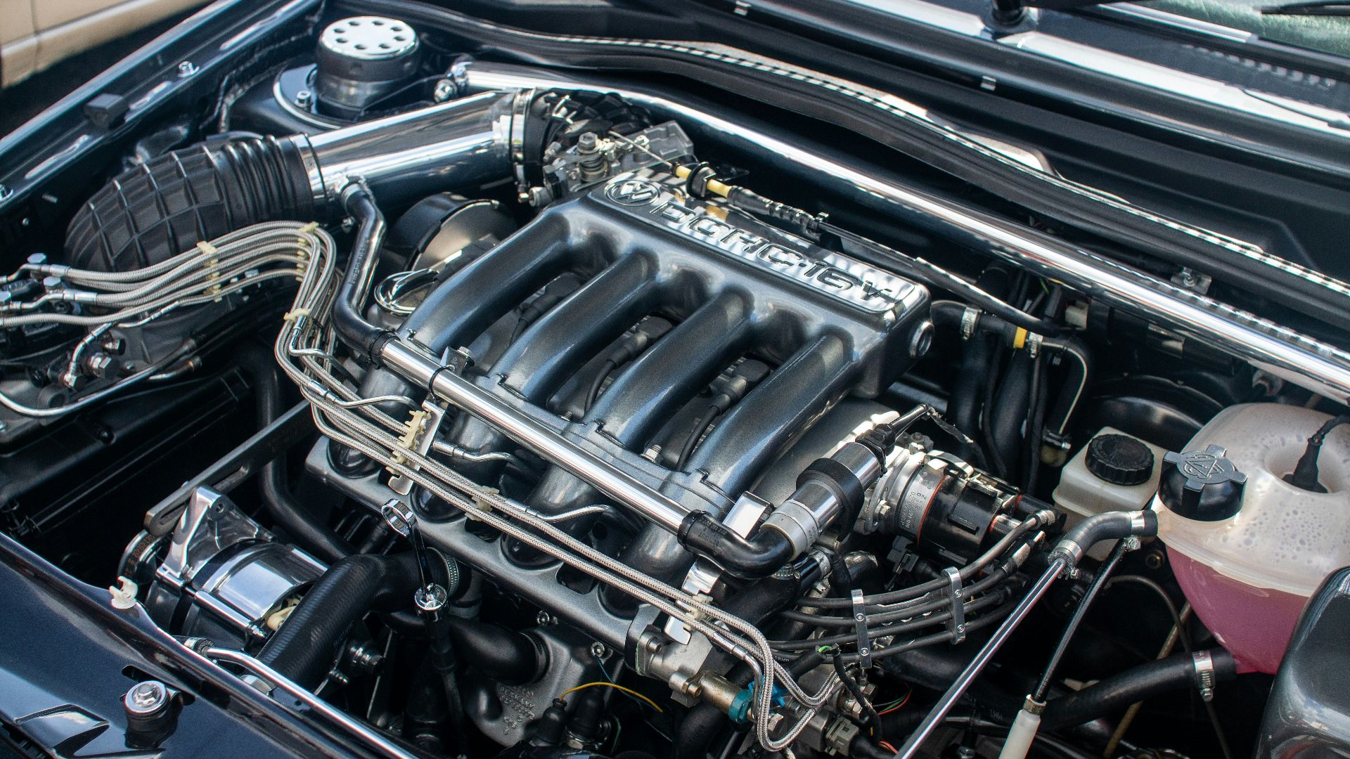 The engine compartment of a car with the hood up